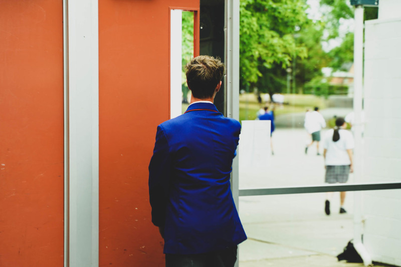 Student Walking Through Door